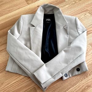 This is a beige XS cropped blazer from ZARA.